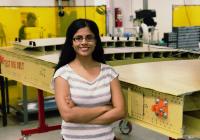 Krithika stands next to a model wing at the Boeing Advanced Research Center at UW.