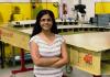 Krithika stands next to a model wing at the Boeing Advanced Research Center at UW.